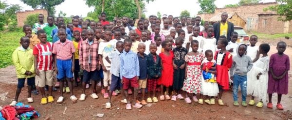 a large group of children in brightly colored new clothes and shoes