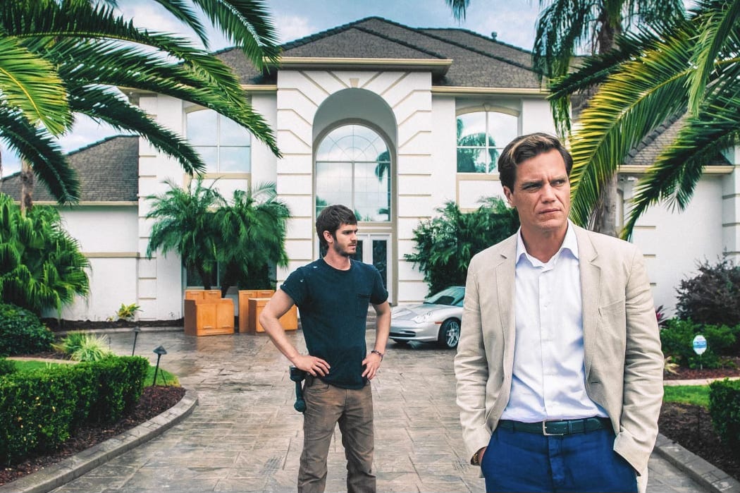Promo image for the 2015 drama film 99 Homes featuring Andrew Garfield and Michael Shannon