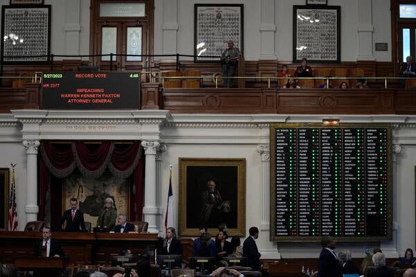 A voting board shows green lights next to most names in a legislative chamber,