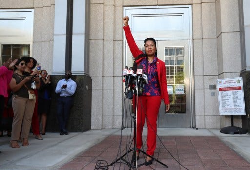 Orange-Osceola State Attorney Monique Worrell ends her press conference with a raised fist outside her former office in the Orange County Courthouse complex on Wednesday, August 9, 2023. Gov. Ron DeSantis on Tuesday announced her suspension at a press conference saying Worrell and her office has been “clearly and fundamentally derelict” in her duty and said her policies justify her removal from office. (Ricardo Ramirez Buxeda/ Orlando Sentinel)