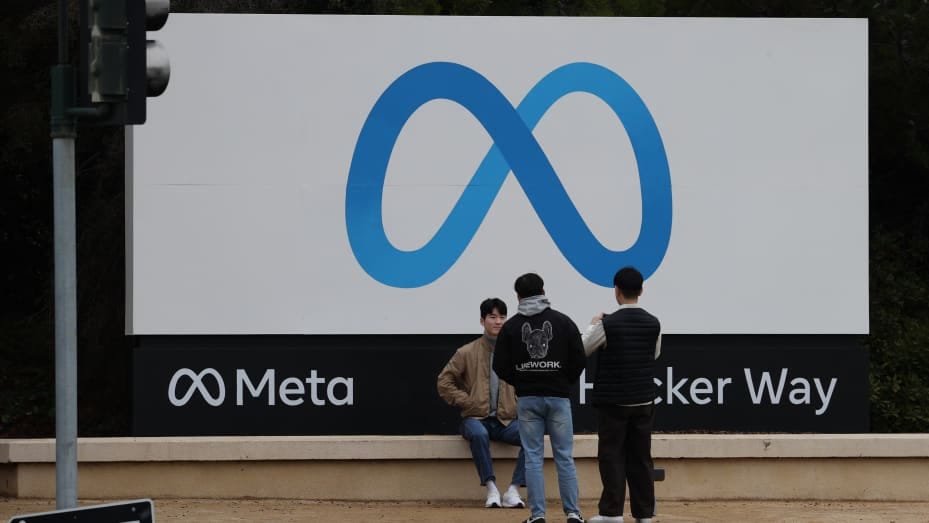 Visitors take photos in front of the Meta sign at its headquarters in Menlo Park, California, United States on December 29, 2022.