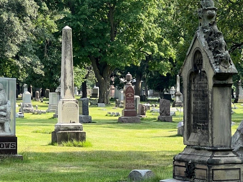 A person sitting in a cemetery

Description automatically generated