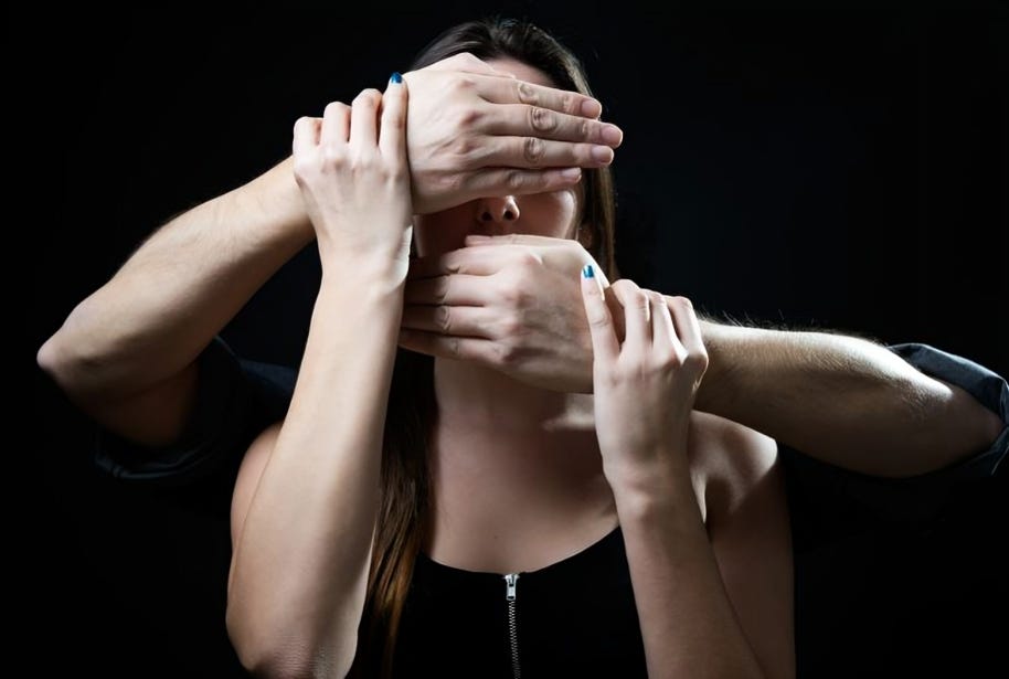 A woman with hands covering her eyes, mouth, and ears representing censorship.