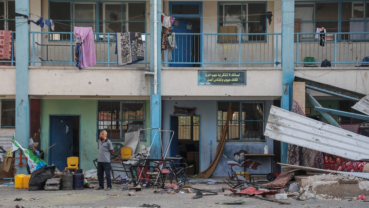 A man standing at the yard of a UN school that was used by Israeli soldiers during the fighting with Hamas but is now vacated, 24 November 2023 (MEE)