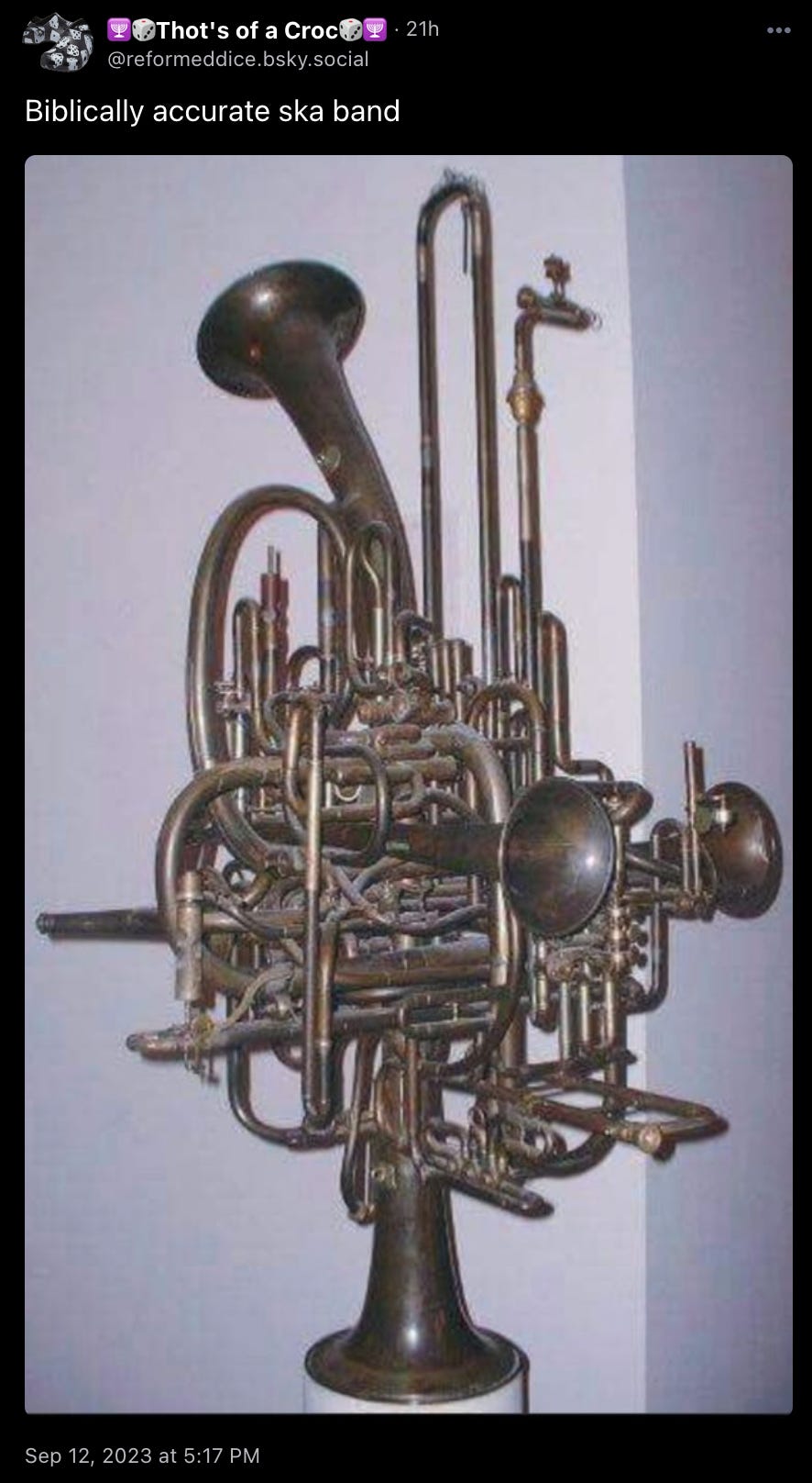 reformeddice.bsky.social: “Biblically accurate ska band” with a picture of an instrument that looks like what you’d get if you shoved the entire horn section of a marching band into a trash compactor. 