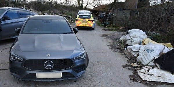 Mercedes car with others in background including a police car