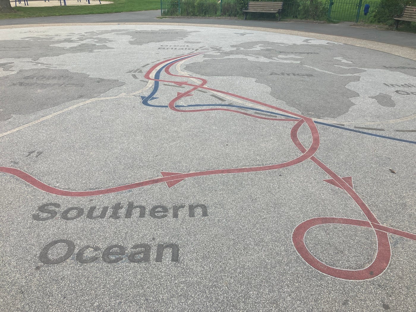 A large circular map of the world made on the tarmac in Stewart park