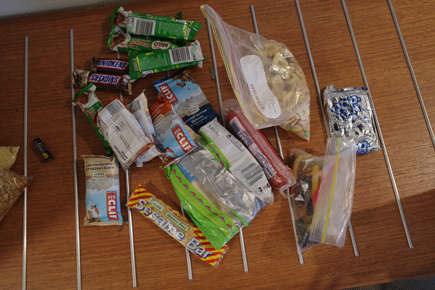 A spread of trail food, including Clif bars, Milo bars, Snickers