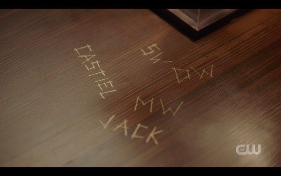 SPN finale Sam Winchester looks at initials carved in table