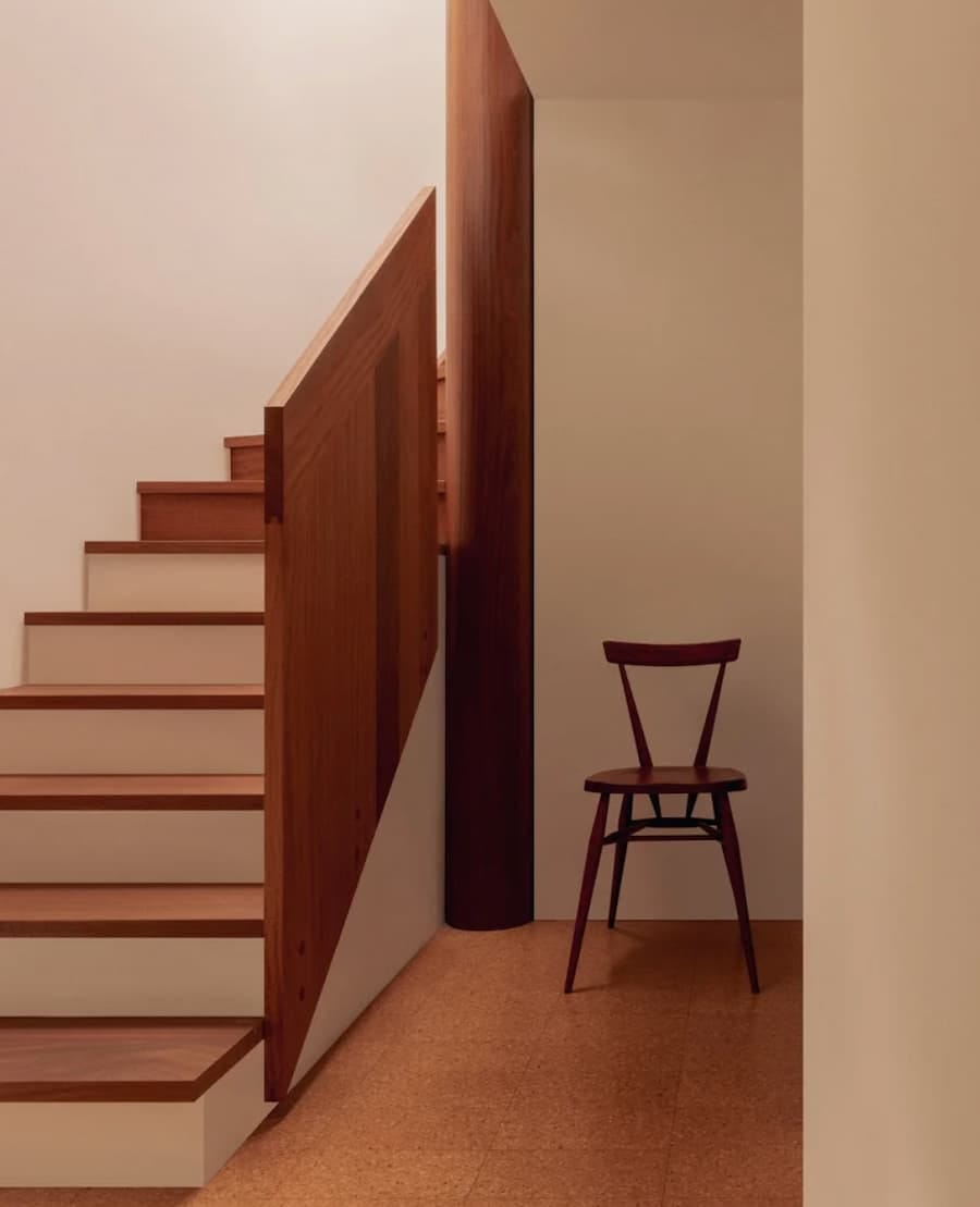 ercol stacking chair positioned as a statement piece by the side of the stairs