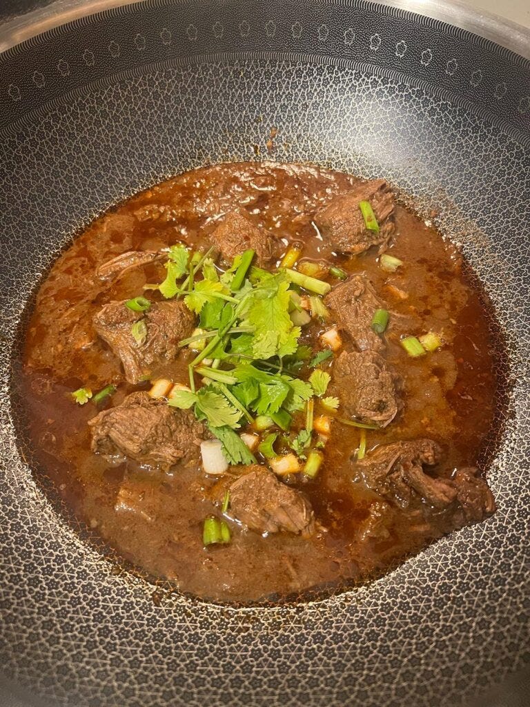 Cooked Beef stew with cilantro and scallion