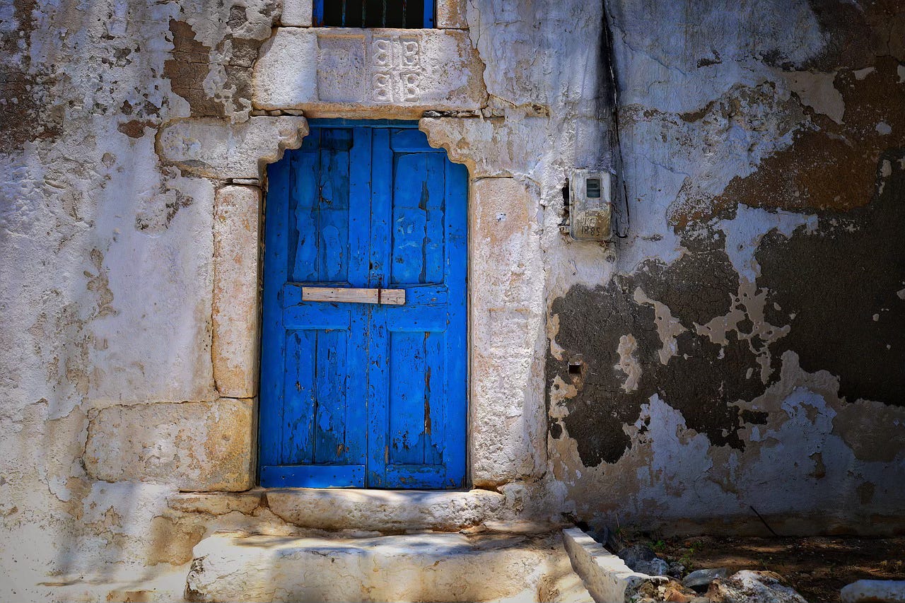 A blue door in a building made of stone