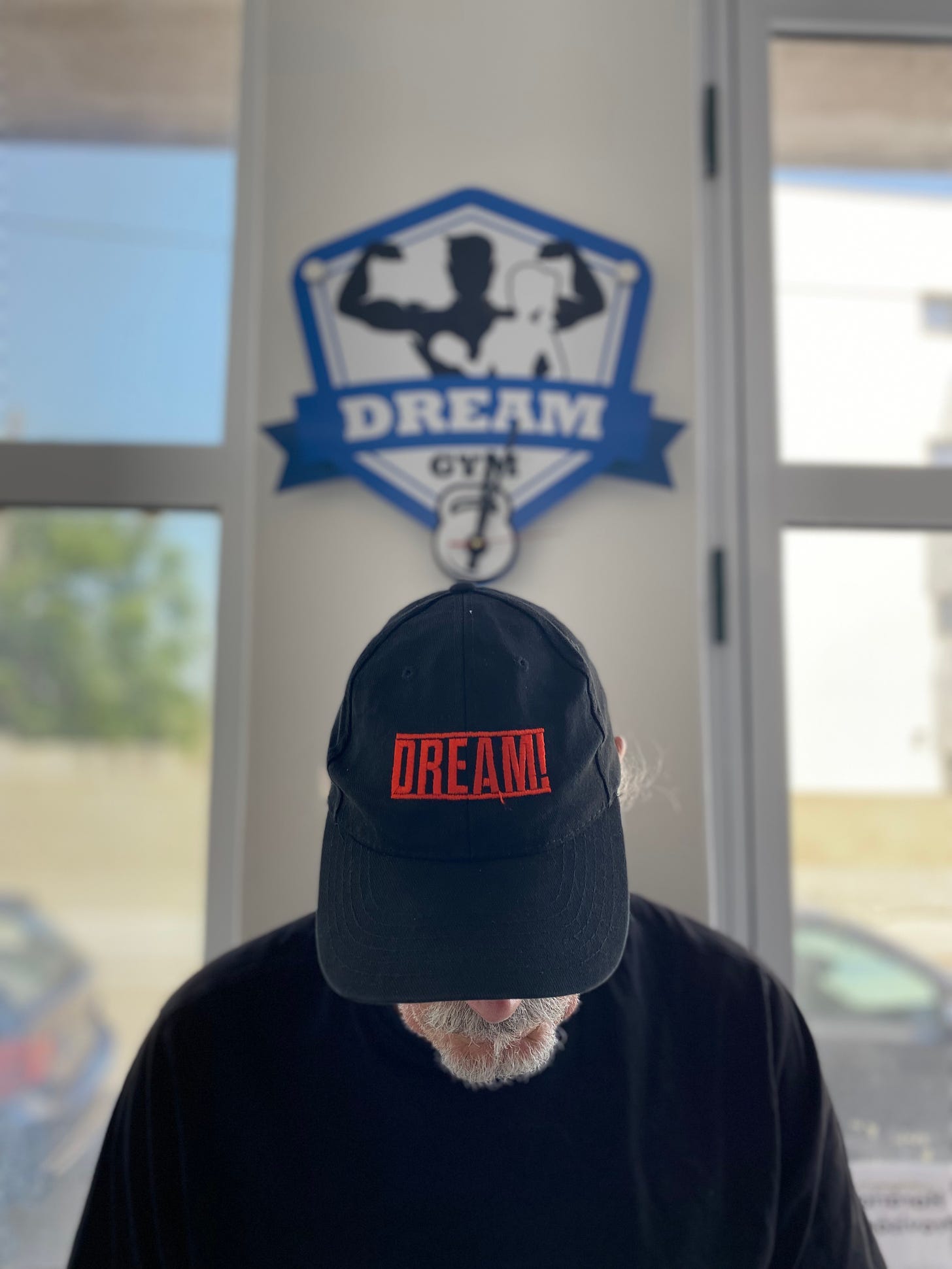 Simon Campbell wearing a DREAM cap in the Dream gym