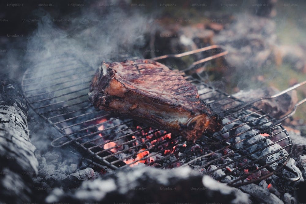 a close up of a steak on a grill