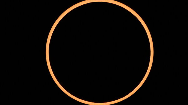 The "ring of fire" effect caused by the annular eclipse of the sun, seen here over Albuquerque, N.M., on Oct. 14, looks like a black circle ringed by a larger, orange circle. 