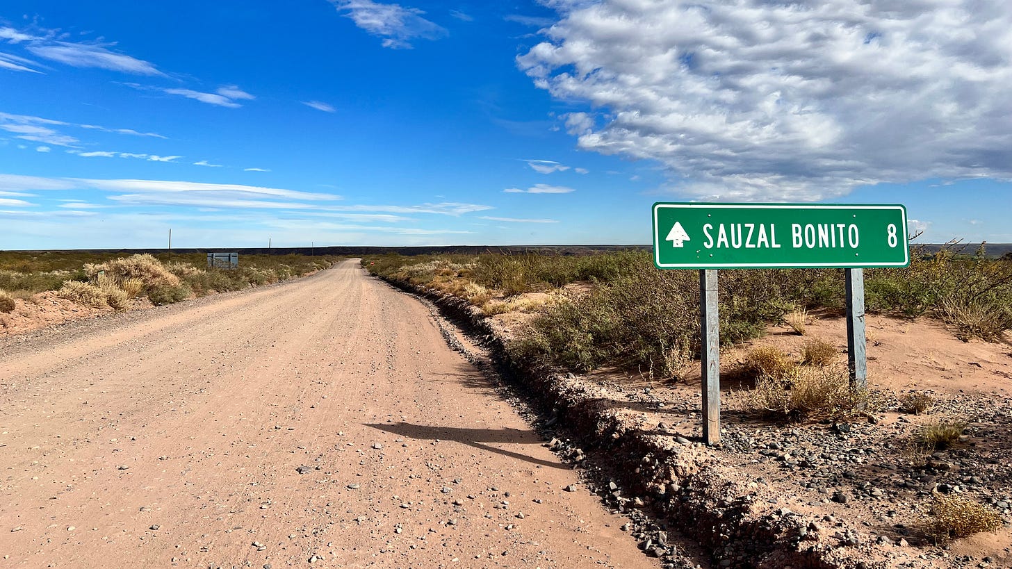 A sign points toward the small town of Sauzal Bonito in Argentina's northern Patagonia region. The town of about 300 people has experienced dozens of small induced earthquakes since fracking operations began nearby. Credit: Katie Surma/Inside Climate News