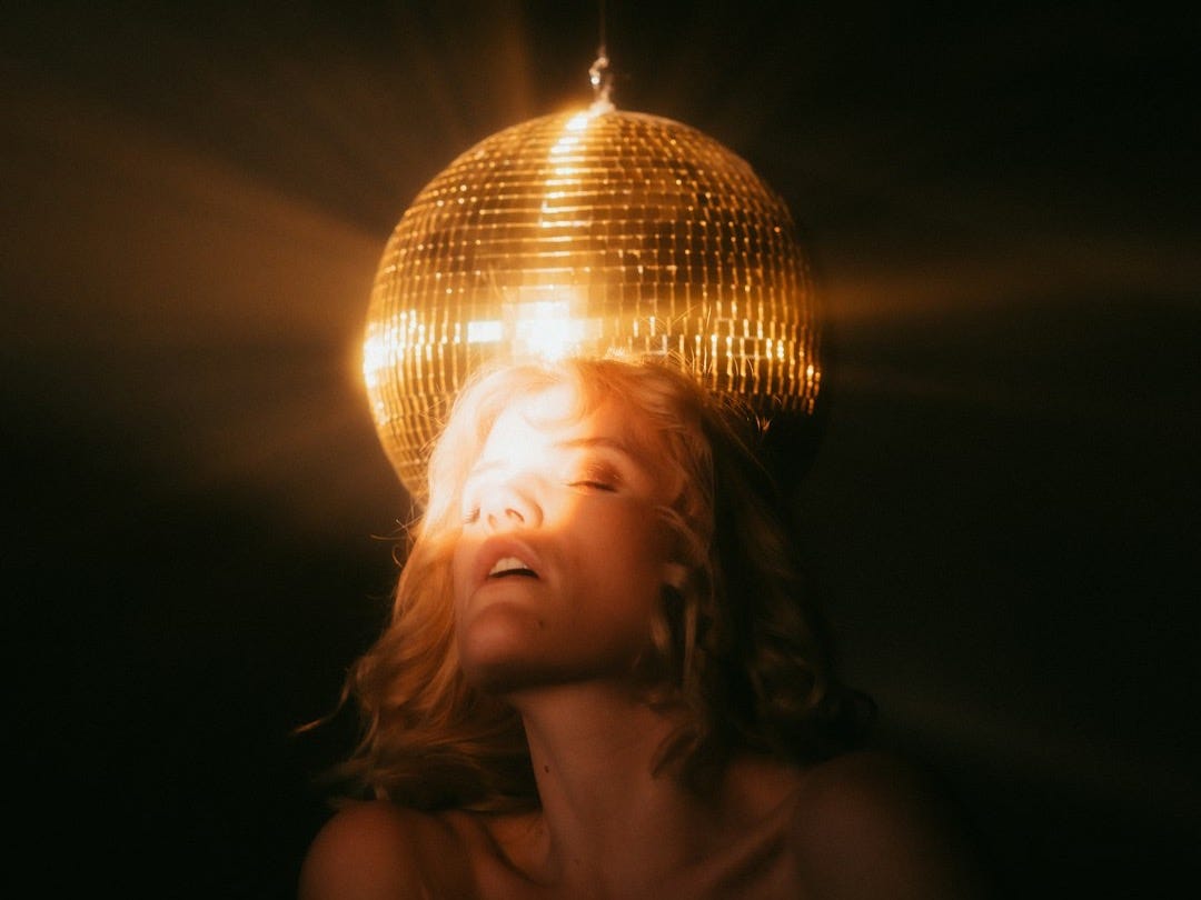 topless woman under white pendant lamp