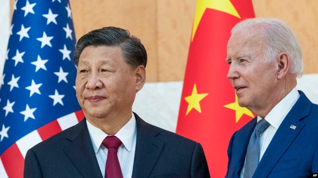 FILE - U.S. President Joe Biden, right, stands with Chinese President Xi Jinping before a meeting on the sidelines of the G-20 summit meeting in Bali, Indonesia, Nov. 14, 2022. 