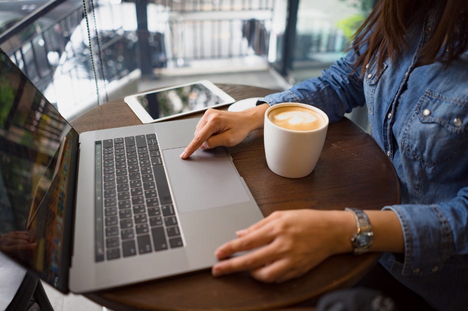 Software engineer in a cafe with a laptop and coffee, embodying tech work-life balance. Software engineer in a cafe with a laptop and coffee, embodying tech work-life balance.