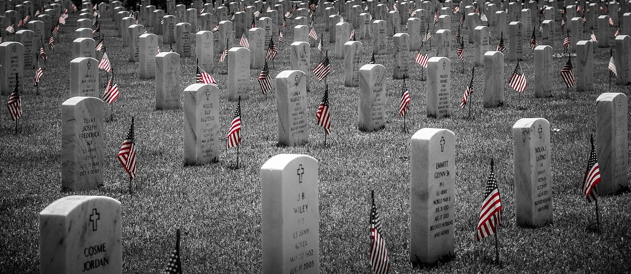 Cemetary, black & white image, with flags in front of the gravestones