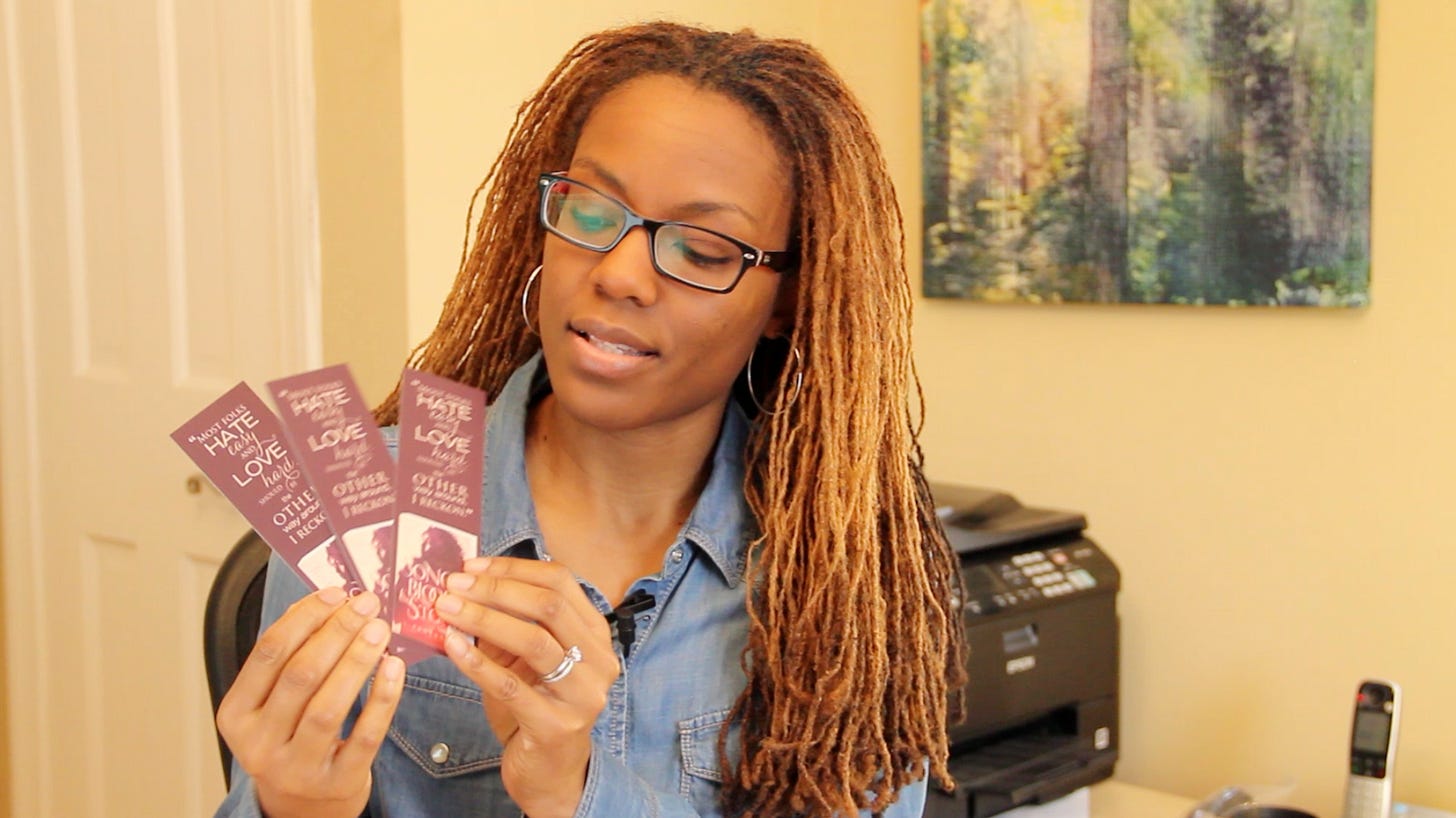 Leslye holding bookmarks circa 2015 Leslye holding bookmarks circa 2015