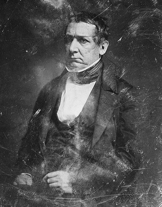 William Meredith in black and white formal half-length seated portrait