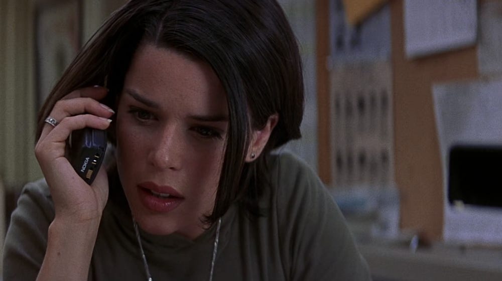 Neve Campbell as Sidney Prescott, answering a phone in Scream 3.