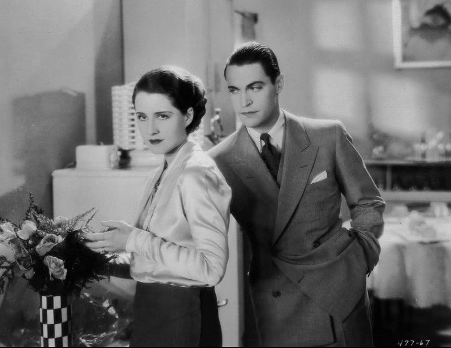 Norma Shearer and Chester Morris in a scene from The Divorcee, as well as a checkered vase that I want