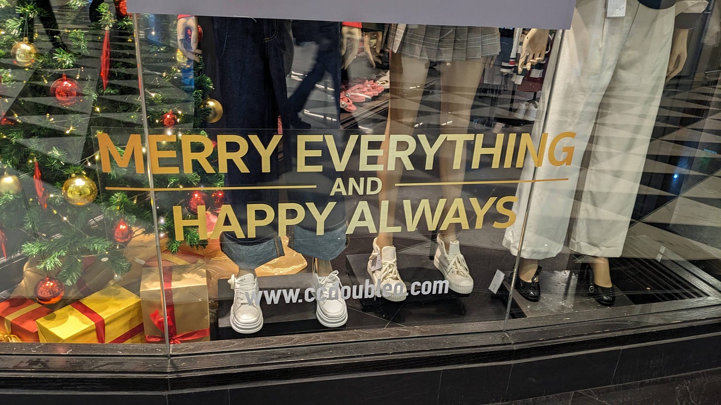 store window says "merry christmas and happy everything"