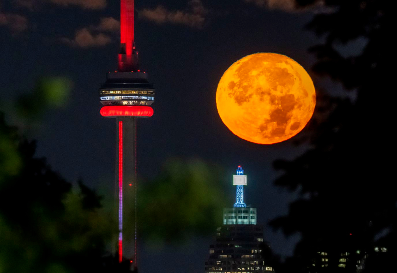 The super blue moon sets behind the CN tower in Toronto, Canada, on August 30.