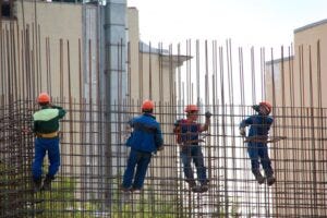Construction workers building a rebar concrete wall