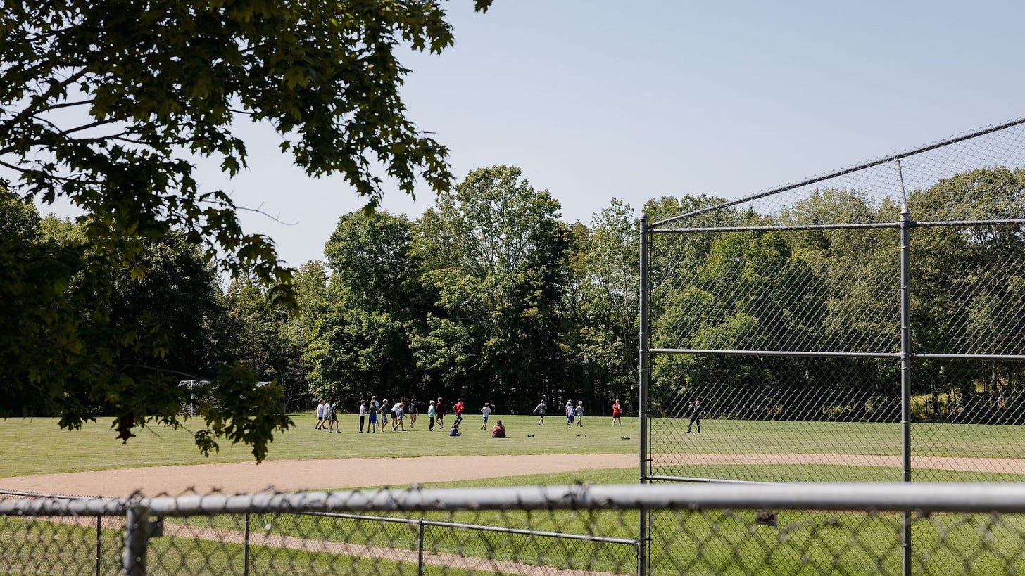 Kids playing on an athletic field.