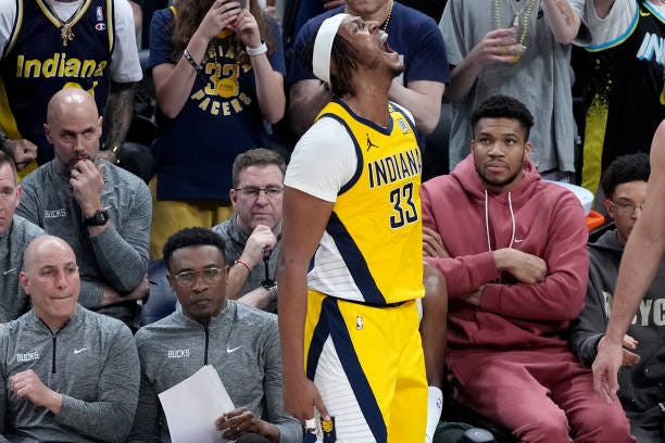 Giannis Antetokounmpo of the Milwaukee Bucks watches as Myles Turner of the Indiana Pacers celebrates a three-pointer during the second half of Game...