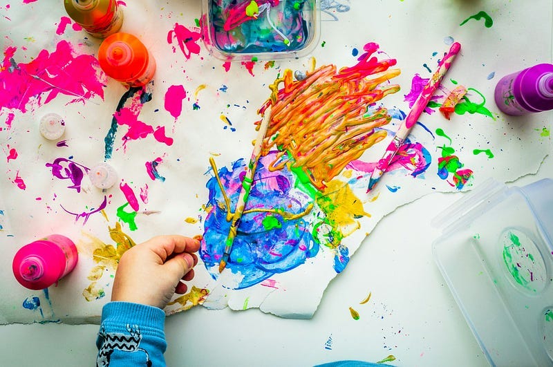 Person painting with colored pens.