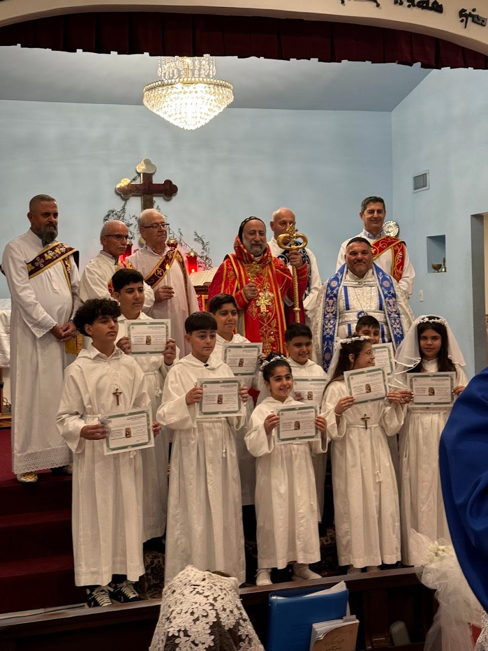 Syriac Orthodox clergy with children in white garments