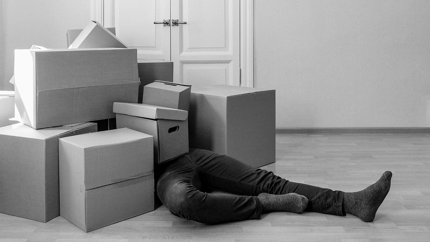 Legs sticking out under a pile of cardboard boxes like the wicked witch of the west