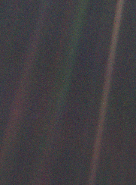 Dark grey and black static with coloured vertical rays of sunlight over part of the image. A small pale blue point of light is barely visible.