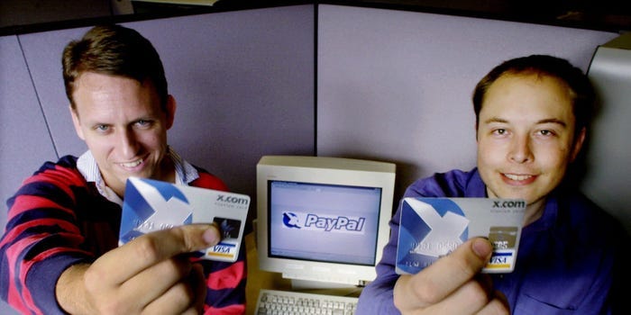 Peter Thiel and Elon Musk holding Visa credit cards