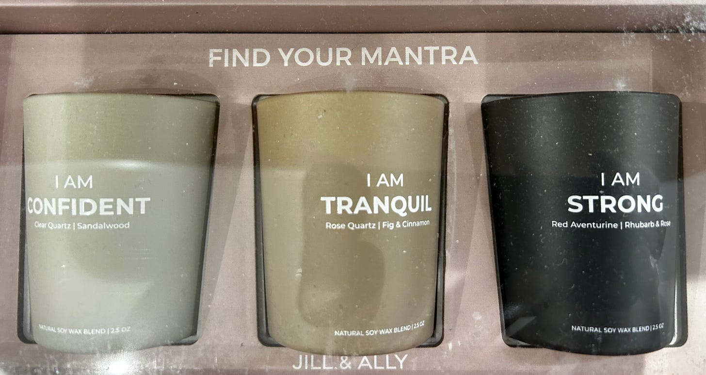 Three candles with different statements: "I am confident," I am tranquil," and "I am strong." They are in a box that says "find your mantra."