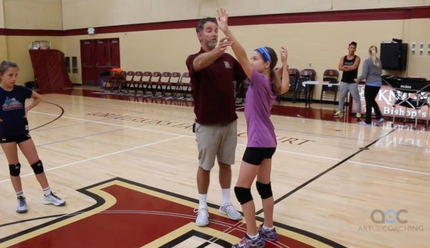 Tod instructs a young volleyball player