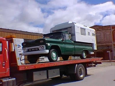 A picture of Steinbeck's Rocinante on a flatbed truck. This helps us understand these Steinbeck travels.