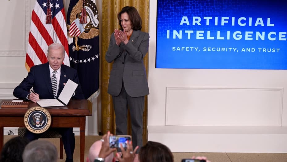 US Vice President Kamala Harris applauds as US President Joe Biden signs an executive order after delivering remarks on advancing the safe, secure, and trustworthy development and use of artificial intelligence, in the East Room of the White House in Washington, DC, on October 30, 2023. Biden issued an executive order October 30, 2023, on regulating artificial intelligence, aiming for the United States to "lead the way" in global efforts at managing the new technology's risks, the White House said. The "lan