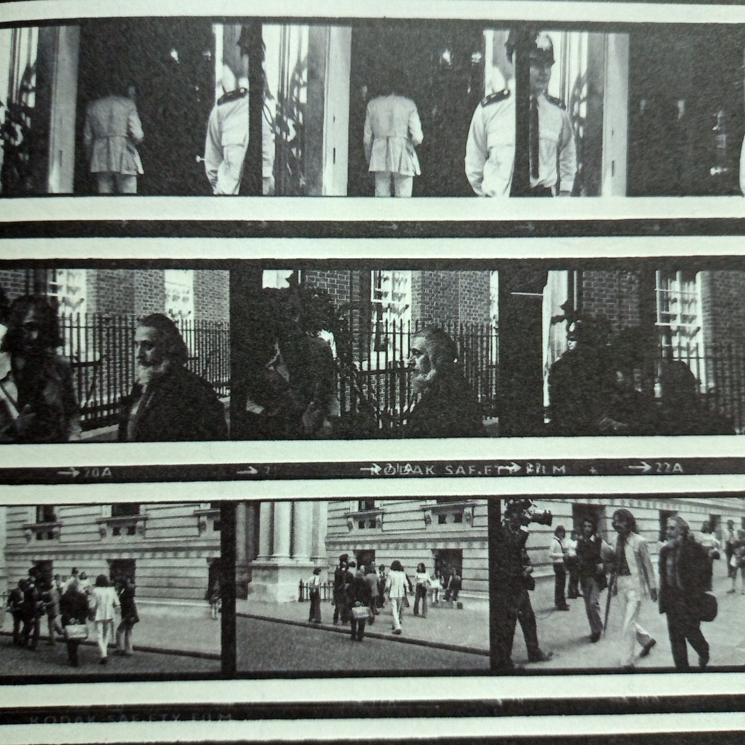 Contact print showing nine photos of Cobbing (in a dark suit) and MacBeth (in a light suit) walking along Whitehall and entering 10 Downing Street