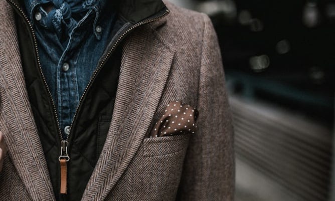 man in brown suit jacket carrying brown backpack man in brown suit jacket carrying brown backpack