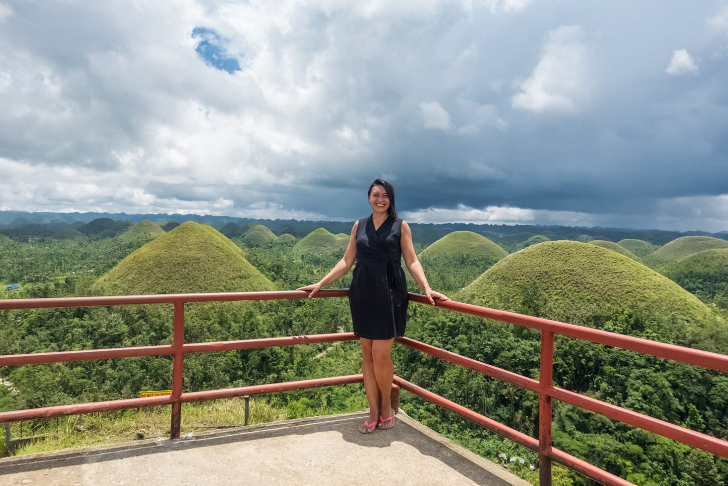 Feeling happy in the amazing painting in green in the Chocolate Hills of Bohol, the Philippines.