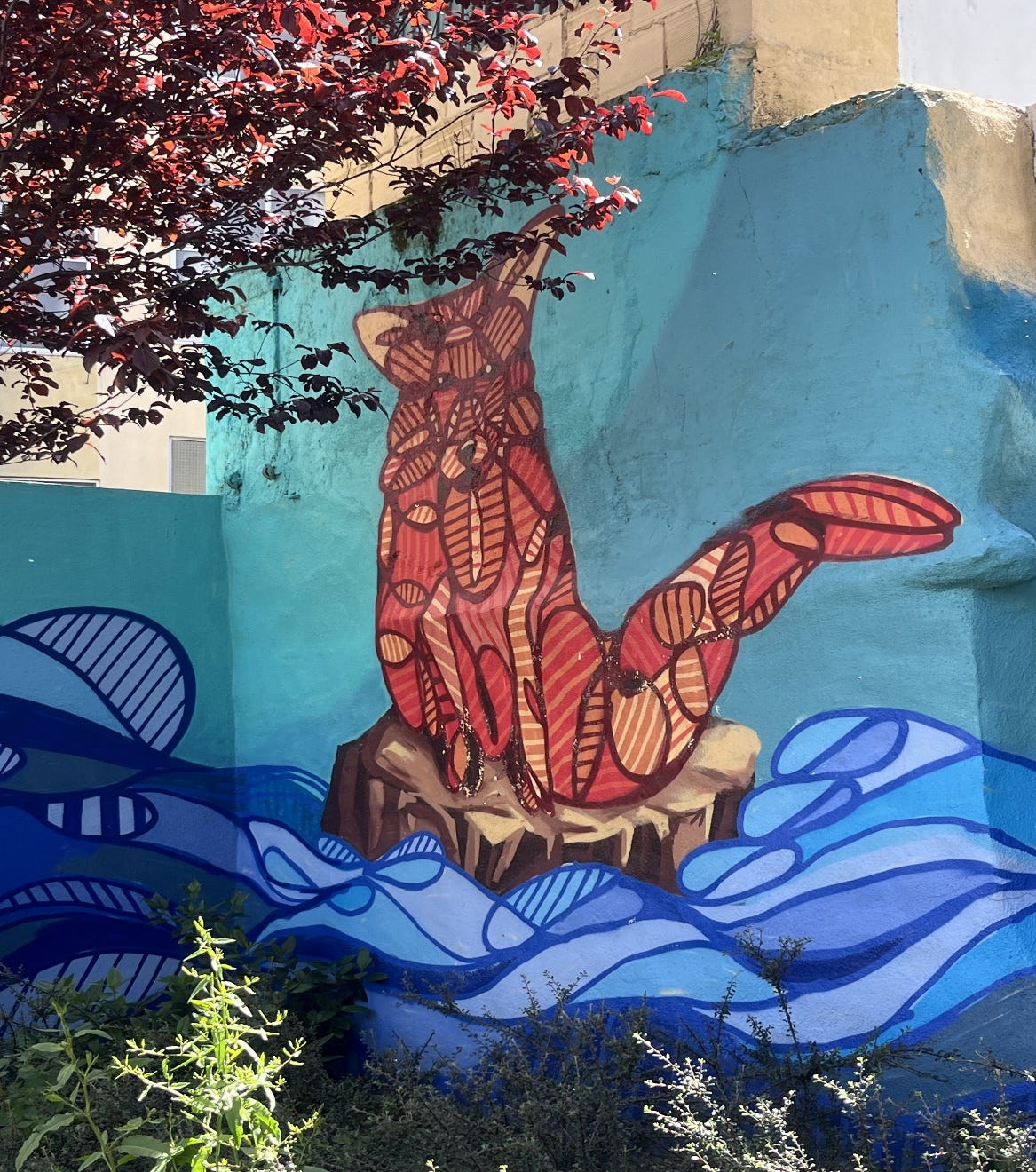 A mural of a fox on a rock