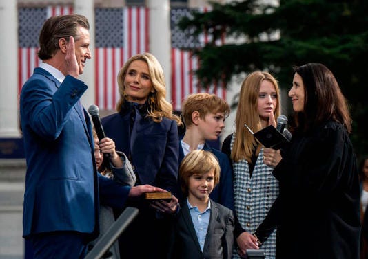 Gavin Newsom is sworn in after a march from the Tower Bridge with various dignitaries and community members on Jan. 6.