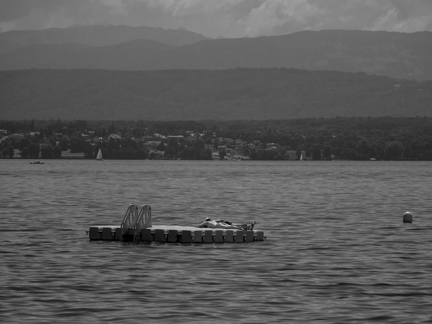 Black and White photo of a lake with a floating pontoon