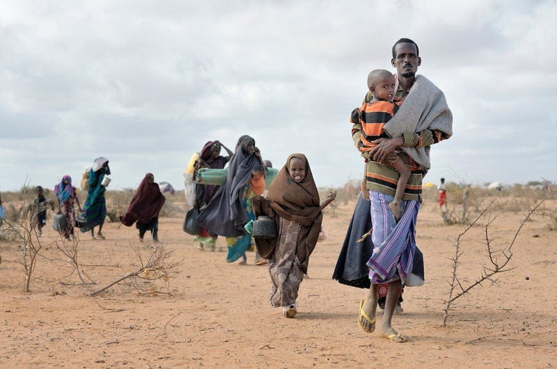 Newly arrived refugees carry their belongings through the Dadaab camp in northeastern Kenya in 2011. Long the world's world's largest refugee settlement, Dadaab swelled with tens of thousands of new arrivals fleeing drought in Somalia. Under "informed consent" rules that require prior approval, the photographer would have had to stop the tired family, explain the intricacies of usage and consent, then get their signatures on the paperwork before allowing them to continue their trek across the hot desert. Photo by Paul Jeffrey. Newly arrived refugees carry their belongings through the Dadaab camp in northeastern Kenya in 2011. Long the world's world's largest refugee settlement, Dadaab swelled with tens of thousands of new arrivals fleeing drought in Somalia. Under "informed consent" rules that require prior approval, the photographer would have had to stop the tired family, explain the intricacies of usage and consent, then get their signatures on the paperwork before allowing them to continue their trek across the hot desert. Photo by Paul Jeffrey.