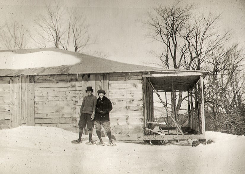 Couple in snowshoes in front of Wapack Lodge